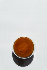 texture of brown honey in a transparent container on a white background free space for text.buckwheat honey