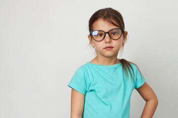 Child girl wearing glasses, white background with copy space
