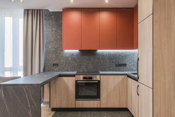 Modern marsala kitchen with black marble and wood elements