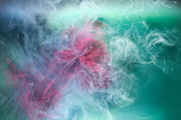 Green pink smoke on black ink background, colorful fog, abstract swirling touch ocean sea, acrylic paint pigment underwater