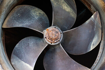 Ship's bronze propeller at the stern of the ship, close-up.