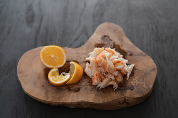 Crab meat with sweet lemon on olive wood board