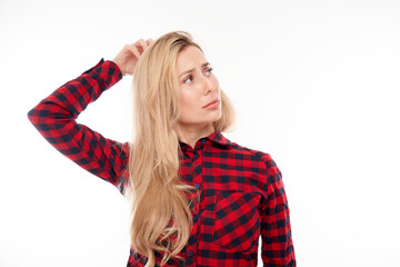 Smart blonde girl in casual holding her head thinks doubts, makes decision isolated on white studio background