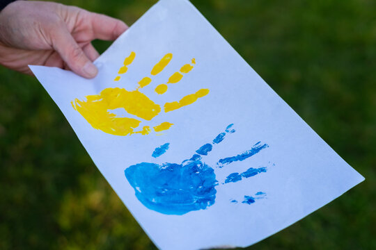 Love Ukraine concept. Hands painted in Ukraine flag color - yellow and blue. Independence day of Ukraine, Flag, Constitution day Education, school, art painitng concept