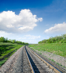 Fototapeta na wymiar railway goes to horizon in green landscape