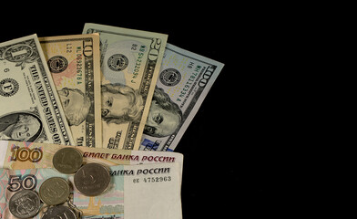 Russian rubles and American dollars on a black background