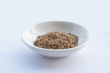 Bowl of mixed pepper and salt  isolated on white. Vietnamese pepper and salt seasoning