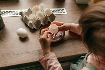 Close up of little girl planting seeds in a eggshells