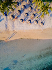 drone view at a beach from above in Mauritius, drone view with umbrella and sunbed on the beach. 