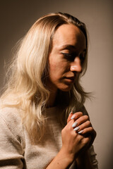 Fototapeta premium A young woman with a very sad face crossed her arms and prayed.