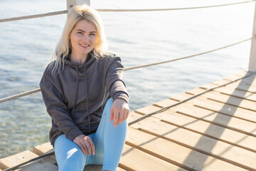 A sexy woman on floating pontoon towards a posh resort. Lifestyle and recreation.