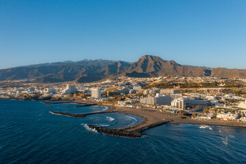Aerial of Costa Adeje and Playa de las Americas area, Tenerife, Canary Islands. Birds eye view from above golden beaches and Atlantic ocean at sunset. Tenerife in summer, vacation in Spain
