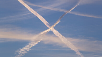Two crossing contrails in the blue sky look like Scottish flag