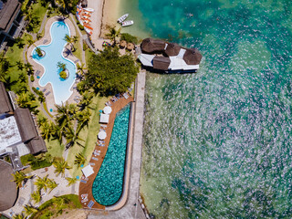 tropical pool with beach chairs and umbrellas, swimming pool in Mauritius at a sunny day
