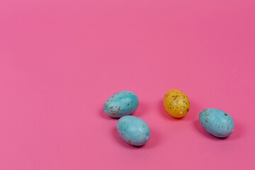 Colorful Easter eggs on pink background. Place for the inscription. Easter.