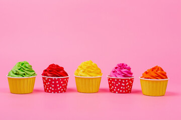 Birthday cupcakes on a pink background. Place for the inscription.