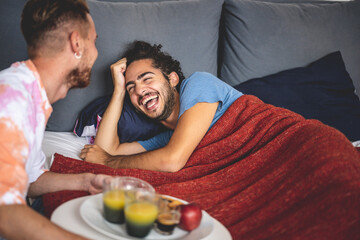 happy gay couple breakfast morning at bed, two young married man at home, lgbt people