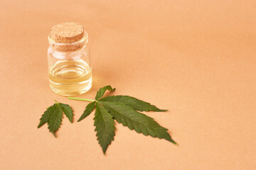 Cannabis essential oil. CBD oil extract in dropper bottle with cannabis green leaf Marijuana. Medical marijuana. Herbal medicine plant. Space for text.