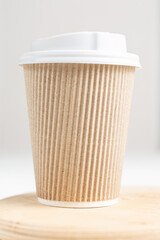 Coffee in paper cup on wood board. Take and go