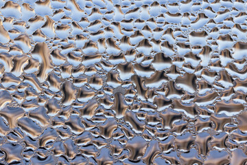 drops of water on the window glass, melted ice. unusual abstraction.