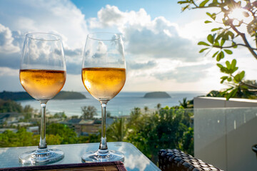 Two rose Wine Glasses On balcony By the Sea.
