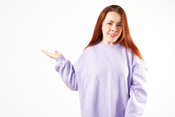 Caucasian woman in violet sweatshirt. Natural look. Smiling. long red hair. White background