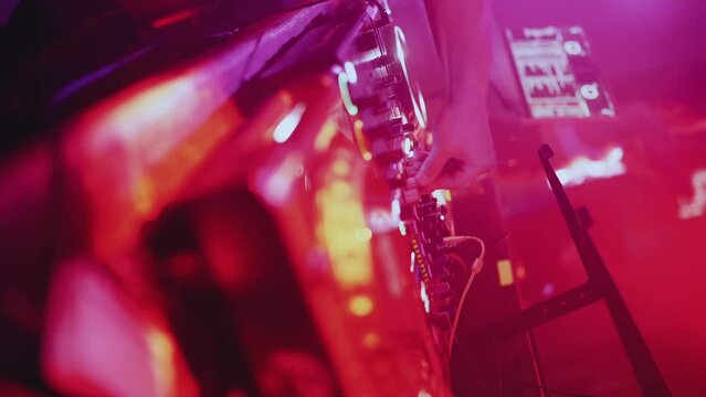 DJ works at the remote control in the club, vertical video