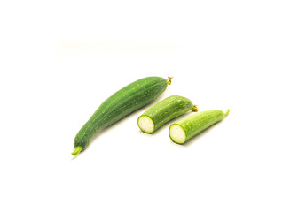 Organic whole luffa (smooth sponge loofah) fruit with two half cuts isolated on white background