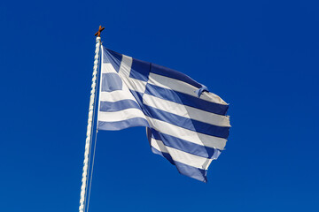 Greek flag on the blue sky background.
