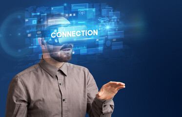 Businessman looking through Virtual Reality glasses