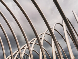 Braided aluminum tubes. Modern architecture. Curved pipes with the sky in the background of the image
