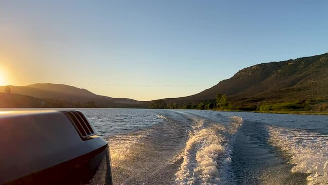 Speed boat wake at sunset on Bulshoek Dam, South Africa