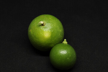 green Lemons fruit. on a black background
