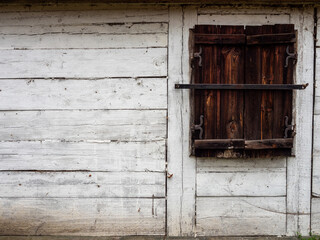 Obraz na płótnie Canvas White wooden house, Brown wooden shutters, Poland