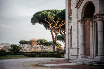 Italian Catholic church with stone pine trees at the bacgkround