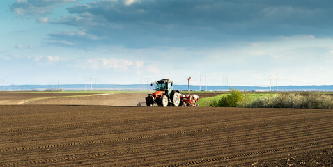 Obraz premium Tractor and seeder for sowing corn