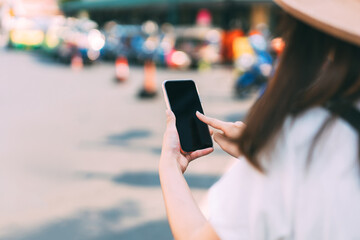 Woman hand touching a smart phone at outdoor for online digital application