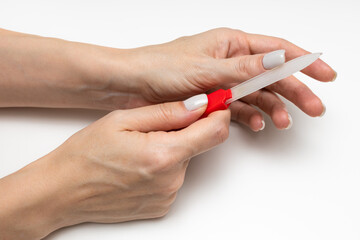 woman polishing her nails with a nail file