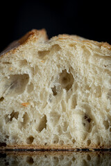 freshly baked artisan ciabatta bread on black mirror kitchen table. close up photo on the table