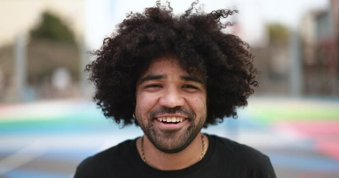 Happy young african man looking on camera outdoor