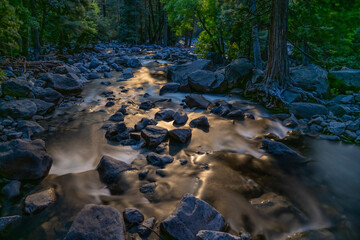 Moonlight dances over rocks and cascades in Yosemite Creek, in Yosemite National Park, near Merced,...