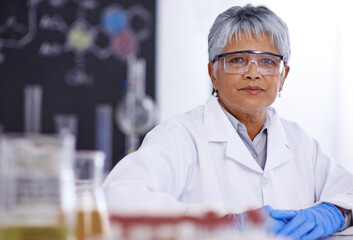 An inspiring woman of science. A senior female scientist working in her lab.