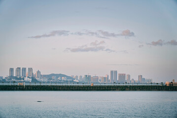 Fototapeta premium Buildings by the sea with dramatic sky in Zhuhai, China