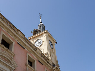 Town Hall of Alcala de Henares with a tower and a clock located in Cervantes Square (Plaza Cervantes). Alcalá de Henares is UNESCO World Heritage Site. Photography with copy space
