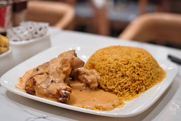 Delicious chicken leg and rice in a restaurant