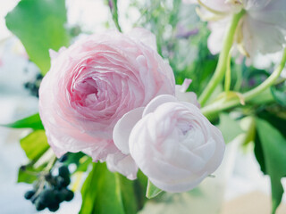 close up of pink and white roses in a bouquet of flowers. 