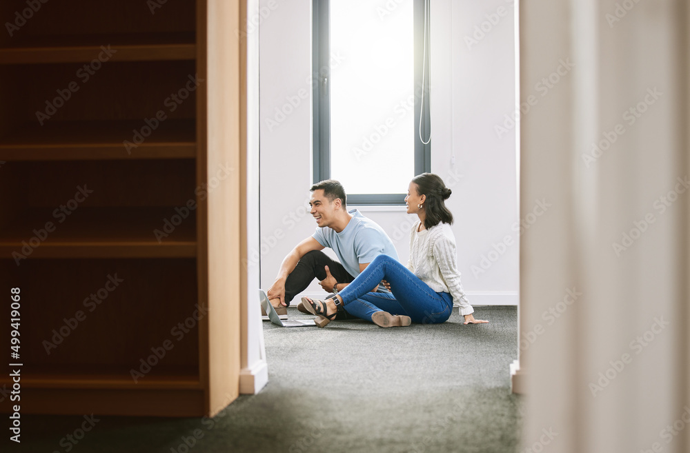 Canvas Prints We have so much to do in this house. Full length shot of a young couple sitting on the floor together in the new house and using a laptop.