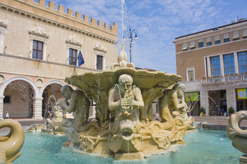 Fountain with figures of newts and dolphins at Piazza Del Popolo in Pesaro, Italy
