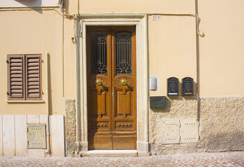 Entrance door of old building in downtown in Pesaro, Italy