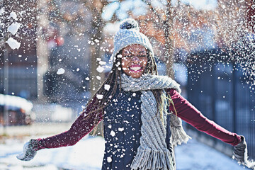 Snow is a celebration of life. Shot of a happy young woman throwing snow on a wintery day outdoors.
